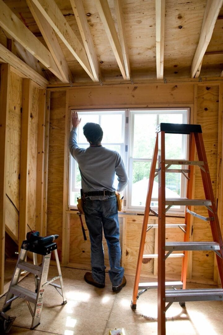 A man standing in front of a window.