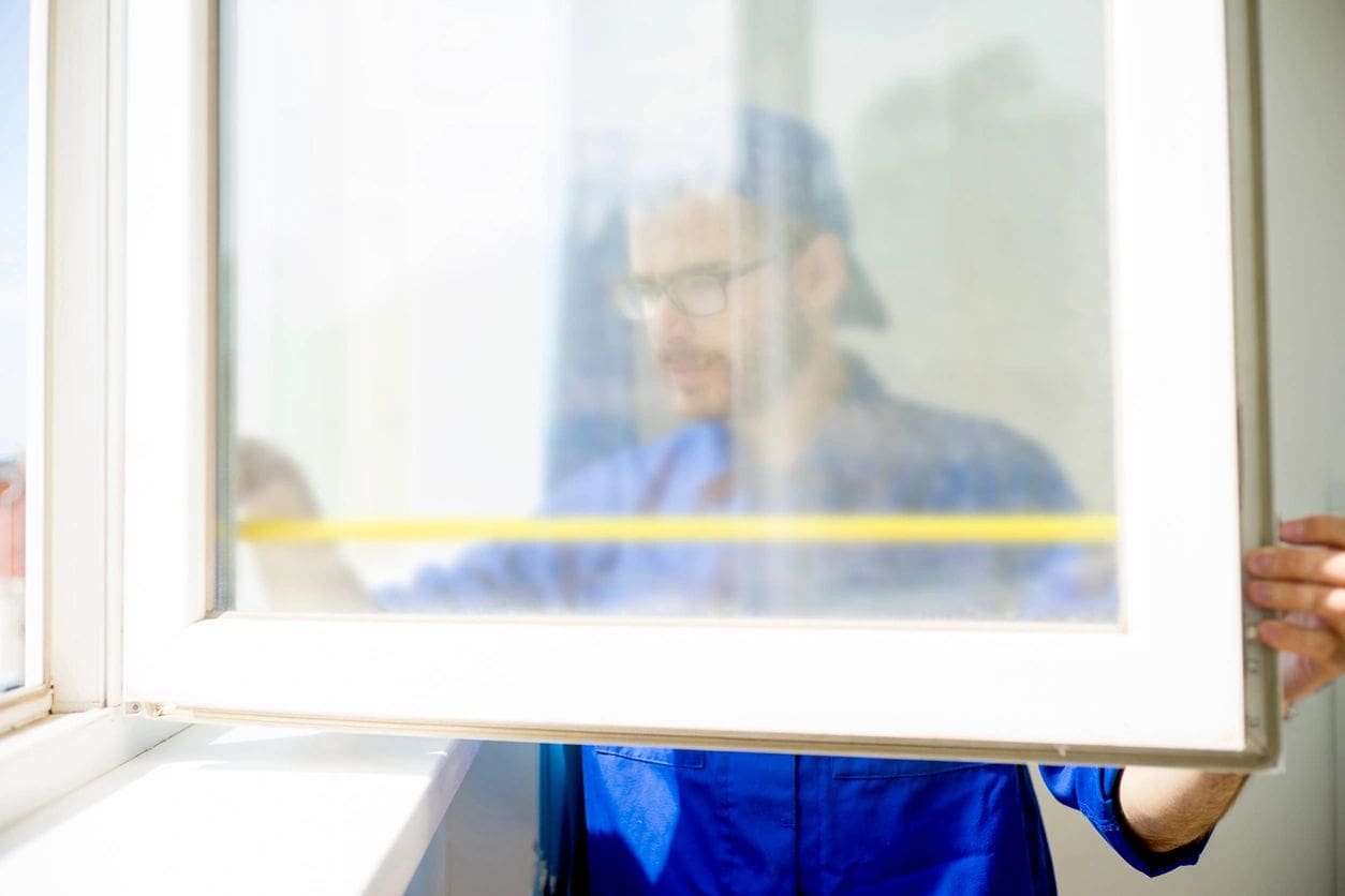 A man sitting in front of a window.